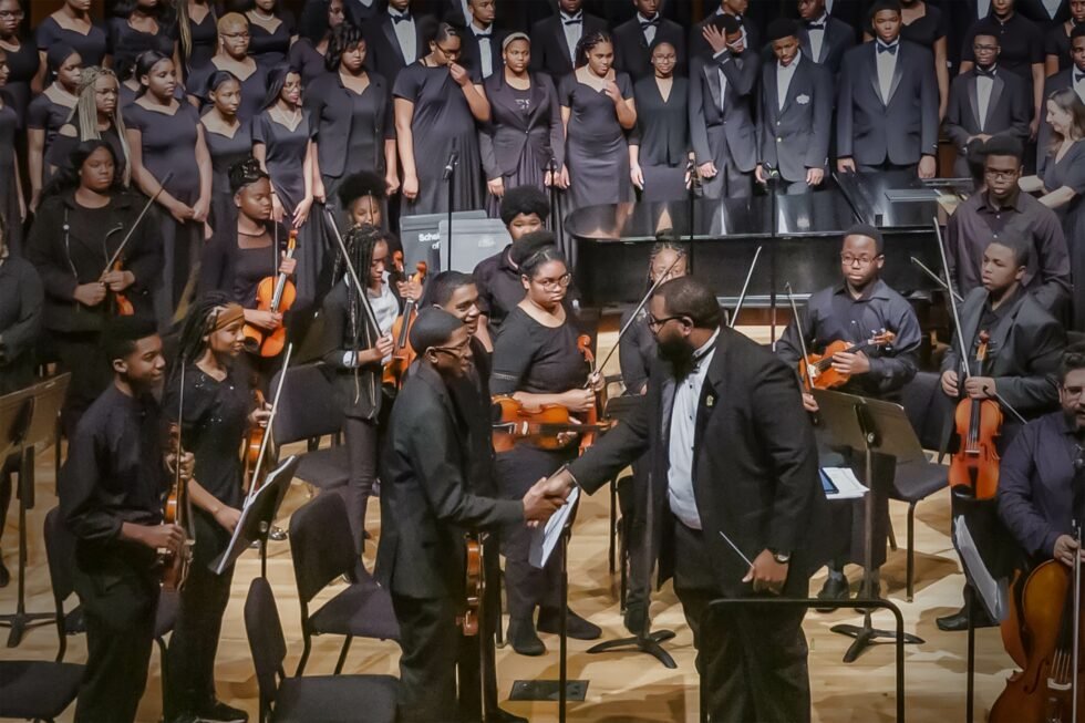 TSCS Masters the Art of Music with December 2022 Winter Concerts demetrius and students shaking hands 980x653 1